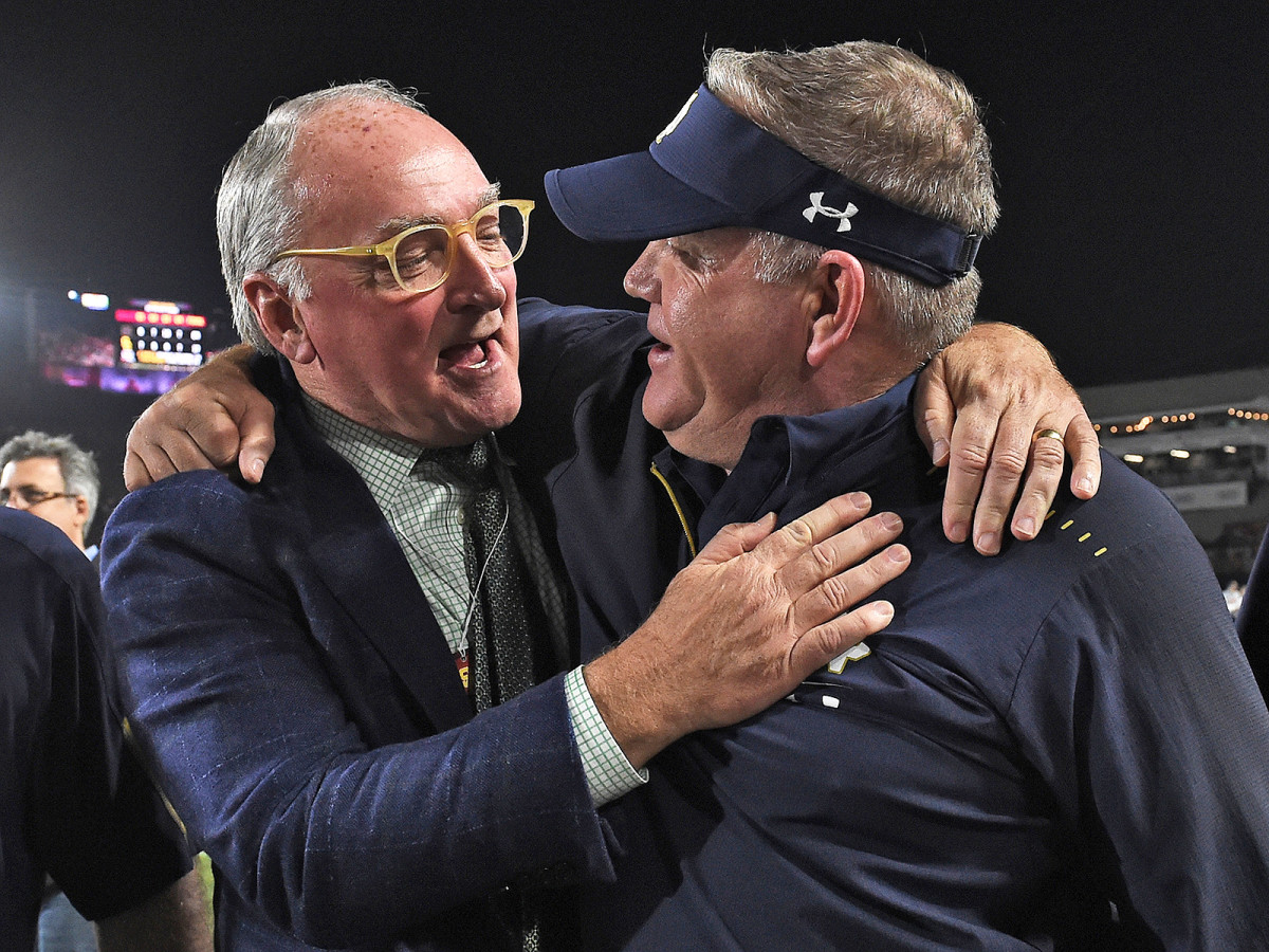 Notre Dame AD Jack Swarbrick (left) and coach Brian Kelly celebrate after the Irish capped off a 12–0 regular season with a win at USC on Nov. 24, 2018.